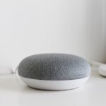 A sleek and modern smart speaker on a clean white surface, perfect for tech-inspired decor.